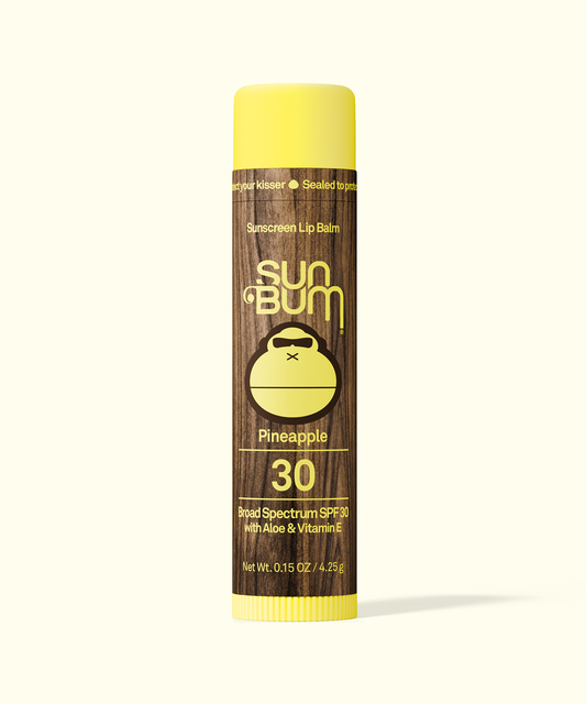 Sun Bum Pineapple sunscreen lip balm on a white background