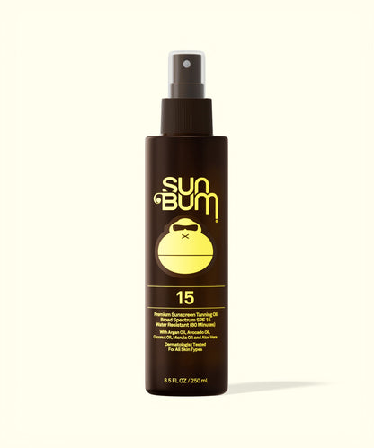 Sun Bum SPF 15 Sunscreen Tanning Oil in a brown spray bottle with yellow logo and text on white background